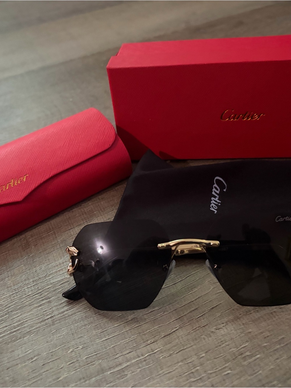 Cartier Rimless Sunglasses with Gold Accents and Black Lenses